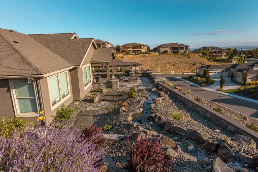 a beautiful home with water features landscaping